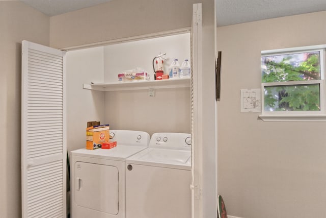 washroom featuring baseboards and washer and clothes dryer