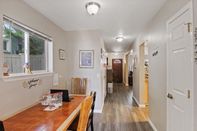 dining area featuring baseboards and wood finished floors