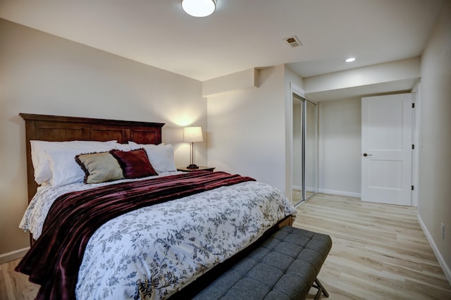 bedroom featuring visible vents, baseboards, and light wood-type flooring