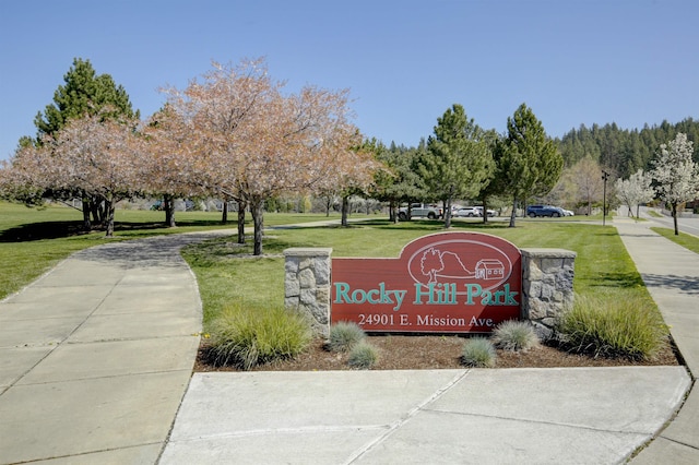community sign featuring a lawn
