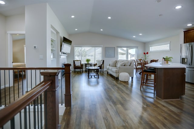 living room featuring recessed lighting, vaulted ceiling, and dark wood finished floors