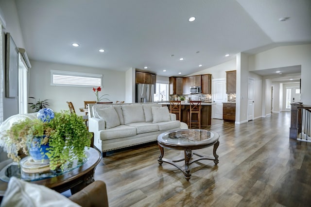 living room featuring recessed lighting, baseboards, lofted ceiling, and dark wood-type flooring