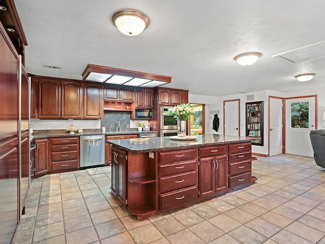 kitchen featuring visible vents, open shelves, built in appliances, a center island, and a sink