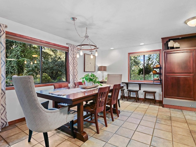 dining space featuring light tile patterned floors and baseboards