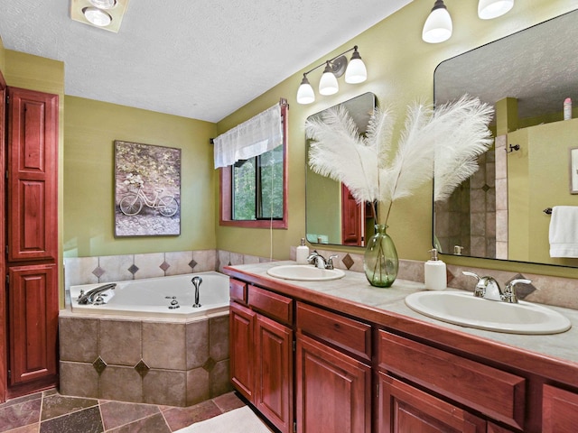 full bathroom featuring a garden tub, a sink, a textured ceiling, and double vanity
