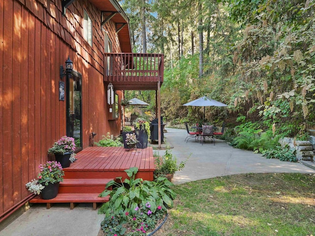 view of patio featuring outdoor dining area and a deck