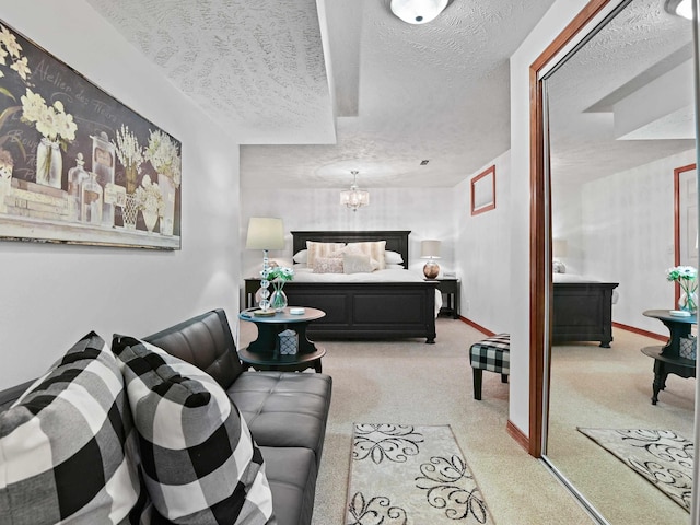 bedroom with baseboards, a textured ceiling, light colored carpet, and an inviting chandelier