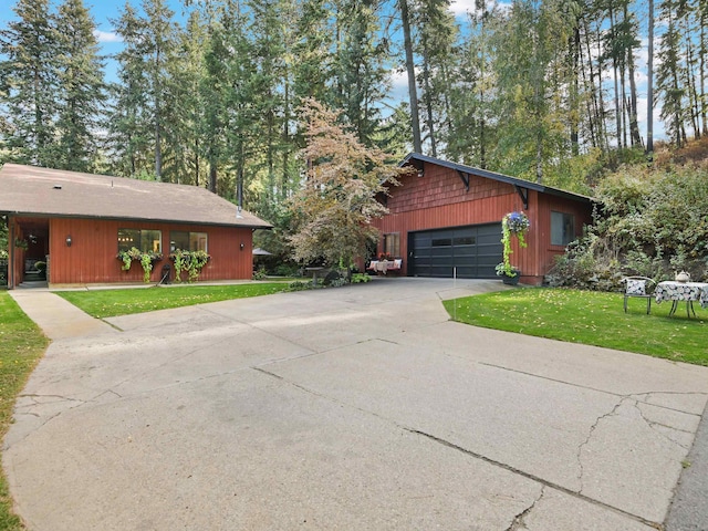 exterior space with a garage, a yard, and driveway