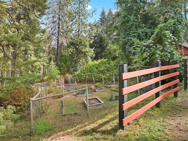 exterior space featuring fence and a vegetable garden