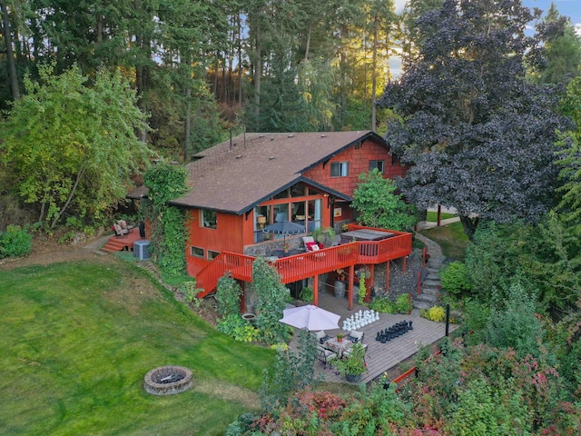 rear view of property featuring stairs, central AC unit, an outdoor fire pit, and a deck
