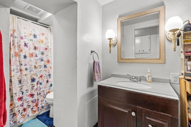 bathroom with vanity, toilet, curtained shower, and visible vents
