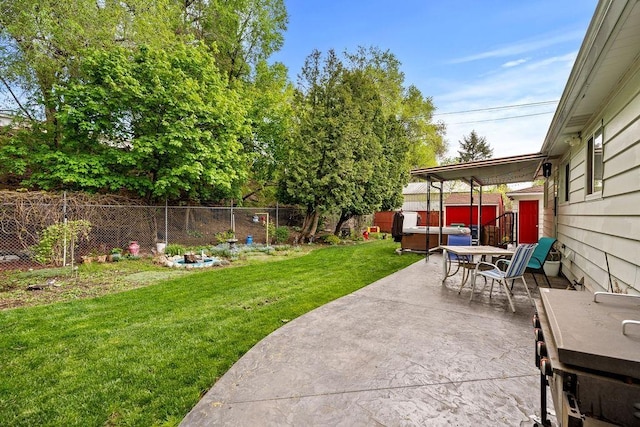view of yard with a hot tub, outdoor dining space, a fenced backyard, and a patio area
