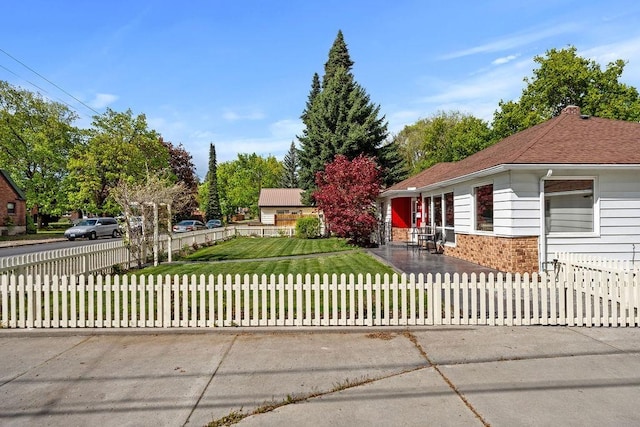 view of front of home with a fenced front yard and a front yard