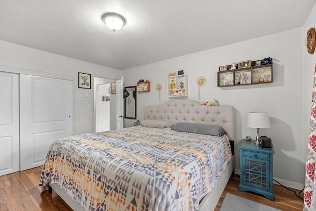 bedroom with a closet and wood finished floors