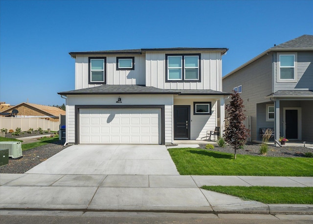 traditional home featuring board and batten siding, driveway, fence, a front lawn, and an attached garage