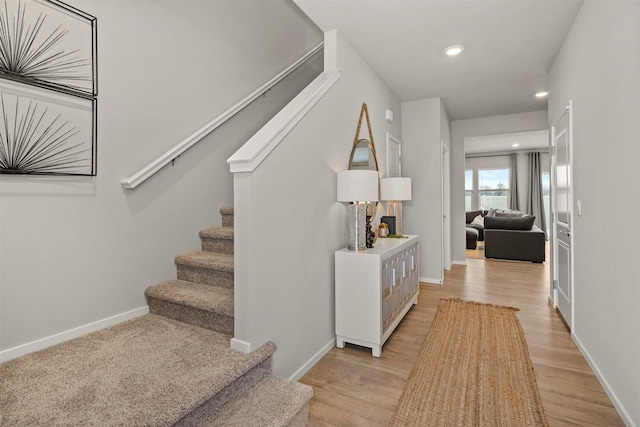 interior space featuring stairs, recessed lighting, baseboards, and light wood-type flooring