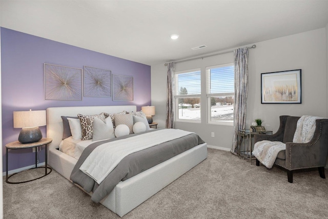 carpeted bedroom with visible vents and baseboards
