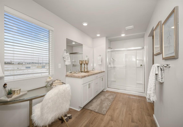 full bathroom with vanity, baseboards, wood finished floors, and a shower stall