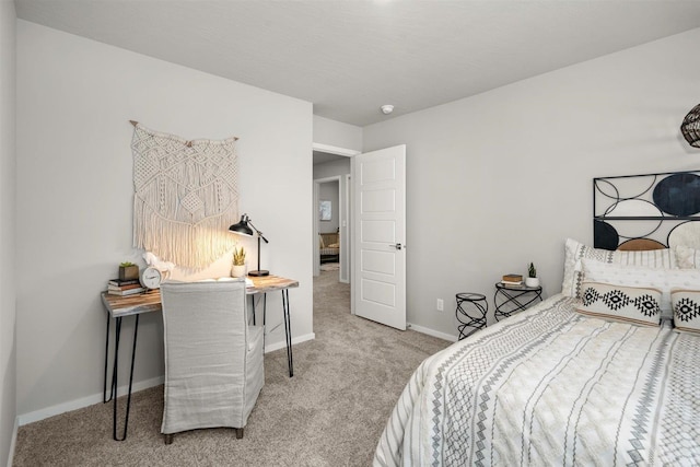 bedroom with baseboards and carpet