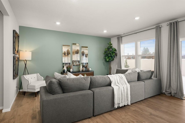 living area featuring recessed lighting, baseboards, and wood finished floors