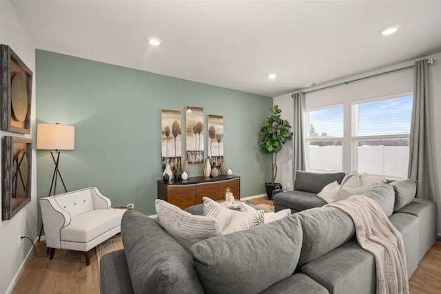 living room with baseboards, recessed lighting, and wood finished floors