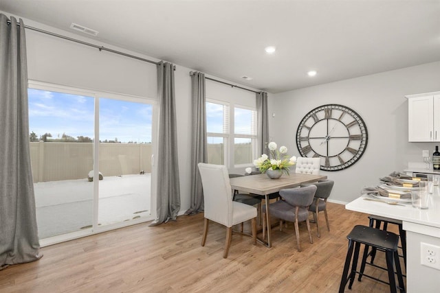dining area featuring light wood-style floors, recessed lighting, and visible vents