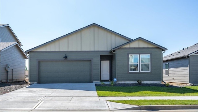 ranch-style house with an attached garage, board and batten siding, a front yard, and concrete driveway