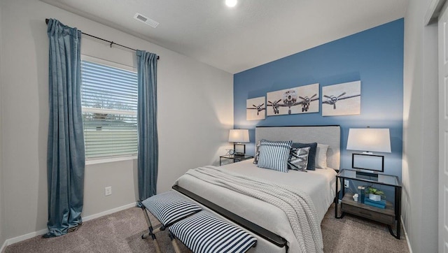 bedroom with carpet floors, baseboards, and visible vents