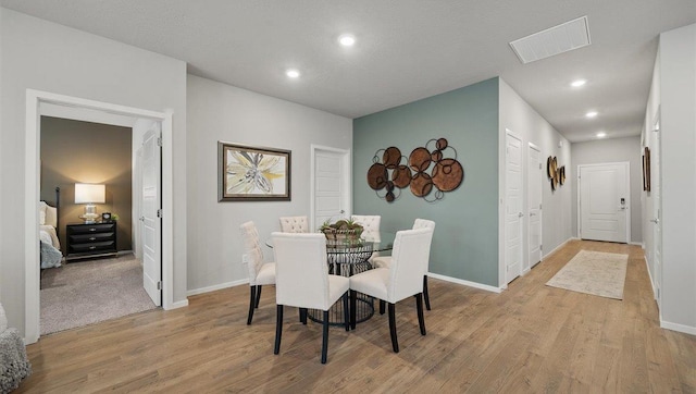 dining area with visible vents, recessed lighting, light wood finished floors, and baseboards