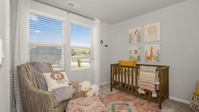 sitting room featuring baseboards, visible vents, and carpet