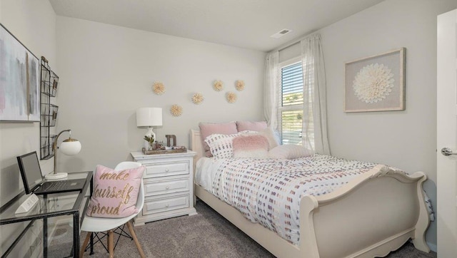 carpeted bedroom featuring visible vents
