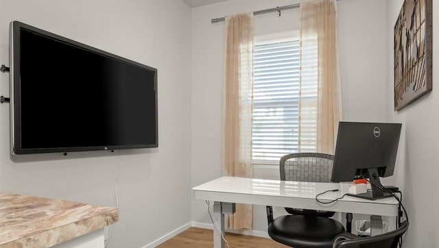 office area featuring baseboards and wood finished floors