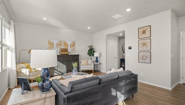 living area with baseboards, recessed lighting, and wood finished floors