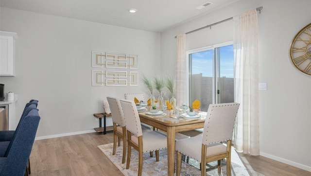 dining room with recessed lighting, baseboards, light wood-type flooring, and visible vents