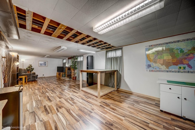 interior space with baseboards and wood finished floors