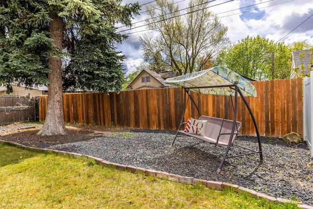 view of yard featuring a fenced backyard and a playground