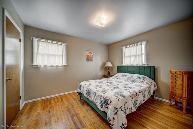 bedroom featuring baseboards and wood finished floors