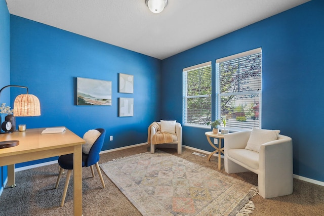 carpeted home office with baseboards and visible vents
