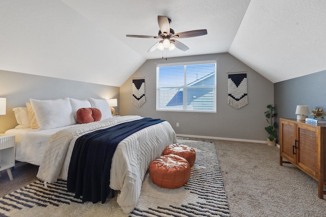 carpeted bedroom with baseboards, ceiling fan, vaulted ceiling, and a textured ceiling