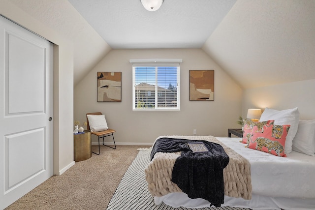 bedroom with baseboards, carpet, and lofted ceiling
