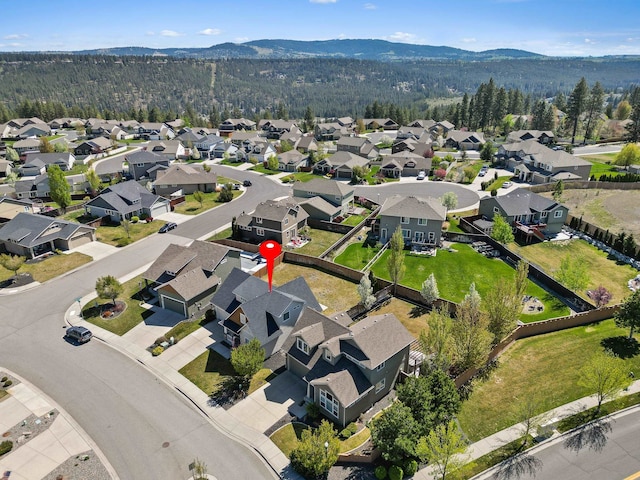 aerial view with a mountain view, a residential view, and a forest view
