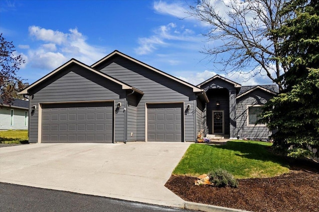 view of front of property featuring concrete driveway, an attached garage, and a front lawn