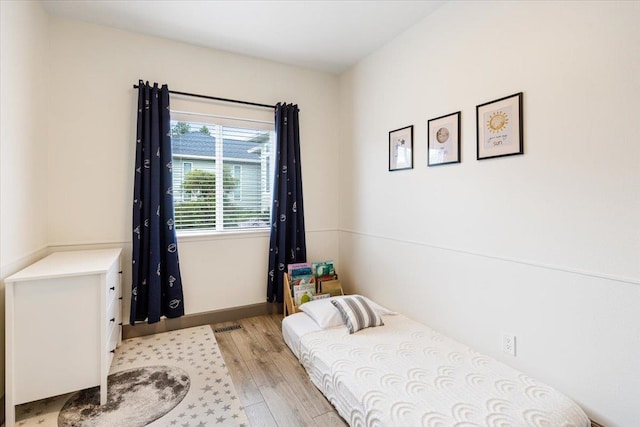 bedroom featuring visible vents and light wood finished floors