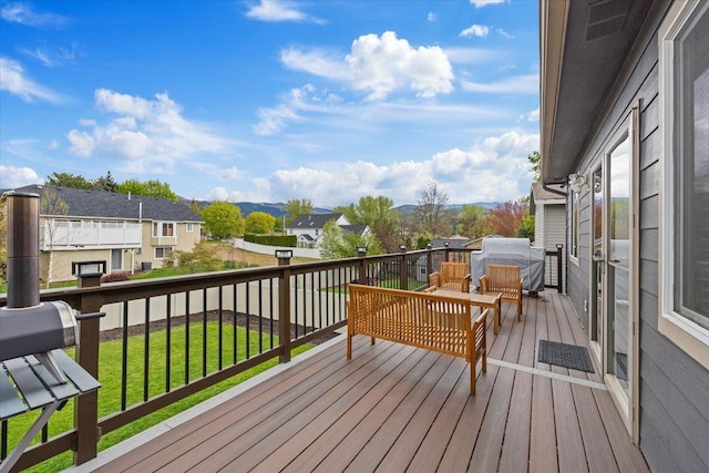 wooden terrace with a lawn and a residential view