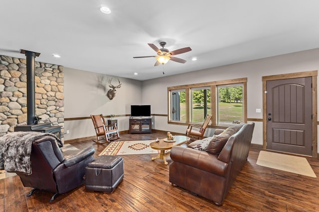5034 Bittrich Antler Rd, Deer Park, WA 99006 - living room with baseboards, a ceiling fan, a wood stove, and hardwood / wood-style floors