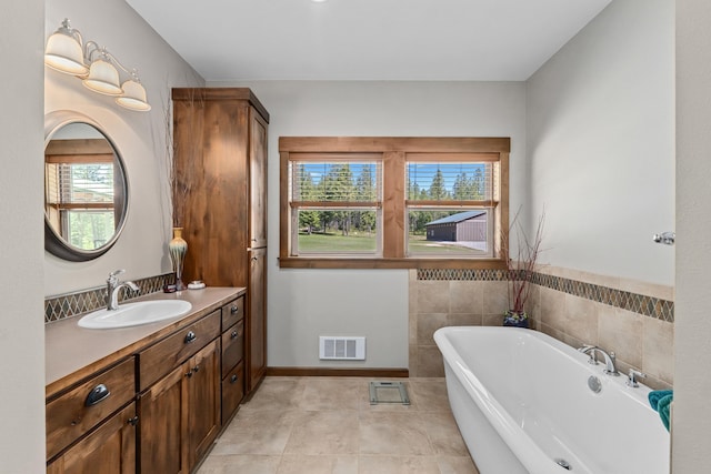 5034 Bittrich Antler Rd, Deer Park, WA 99006 - bathroom featuring a soaking tub, visible vents, a healthy amount of sunlight, and vanity