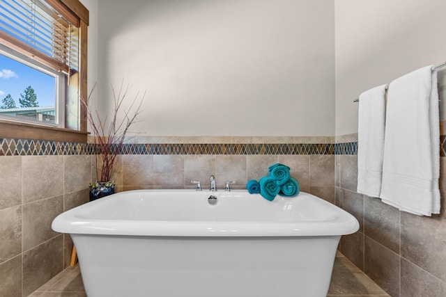 5034 Bittrich Antler Rd, Deer Park, WA 99006 - full bathroom featuring a wainscoted wall, tile patterned flooring, a soaking tub, and tile walls