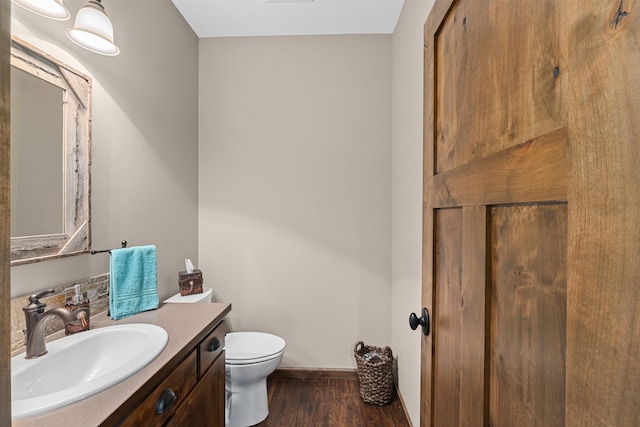 5034 Bittrich Antler Rd, Deer Park, WA 99006 - bathroom with vanity, baseboards, wood finished floors, and toilet
