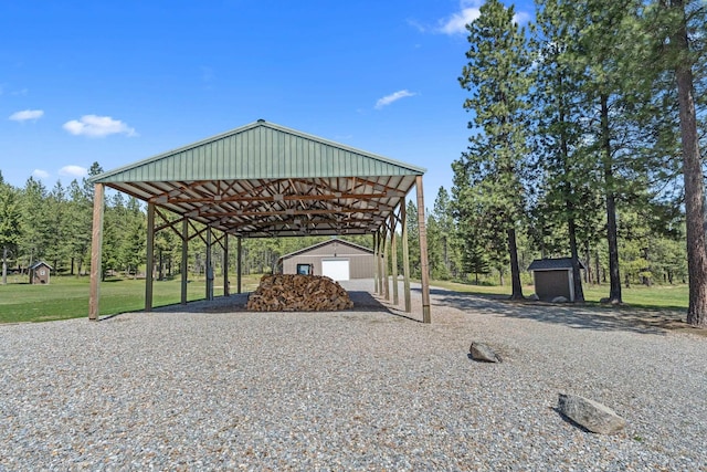 5034 Bittrich Antler Rd, Deer Park, WA 99006 - exterior space with driveway, a carport, an outdoor structure, a storage unit, and a yard