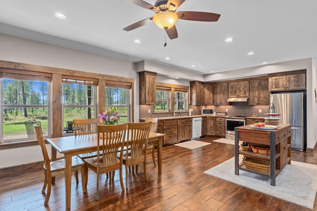 5034 Bittrich Antler Rd, Deer Park, WA 99006 - kitchen with tasteful backsplash, light countertops, a sink, under cabinet range hood, and stainless steel appliances